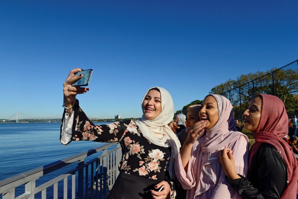 People take photos of each other before a group prayer session for the Muslim holiday Eid al-Adha in the Brooklyn borough of New York City, U.S., September 12, 2016. REUTERS/Stephanie Keith