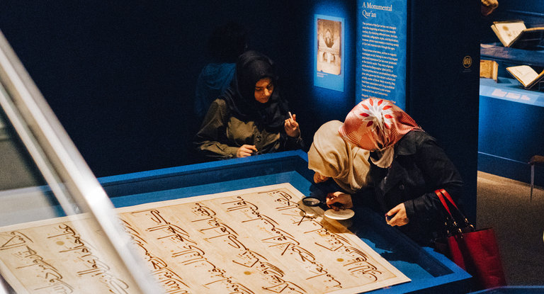Visitors studying a folio from a large Quran dating to about 1400 in the exhibition “The Art of the Qur’an: Treasures From the Museum of Turkish and Islamic Arts,” at the Arthur M. Sackler Gallery in Washington. Photo/Justin T. Gellerson/The New York Times
