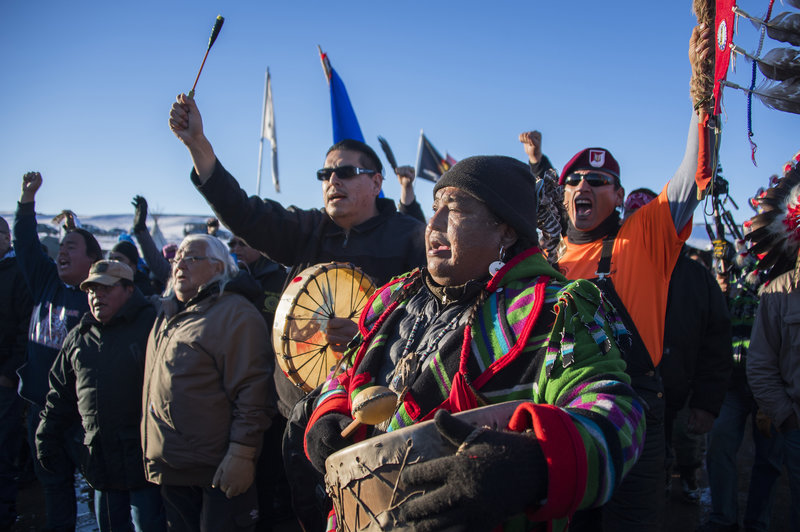 Protesters celebrate at Oceti Sakowin Camp earlier Sunday. The Army Corps of Engineers notified the Standing Rock Sioux that the current route for the Dakota Access Pipeline will be denied. Jim Watson/AFP/Getty Images